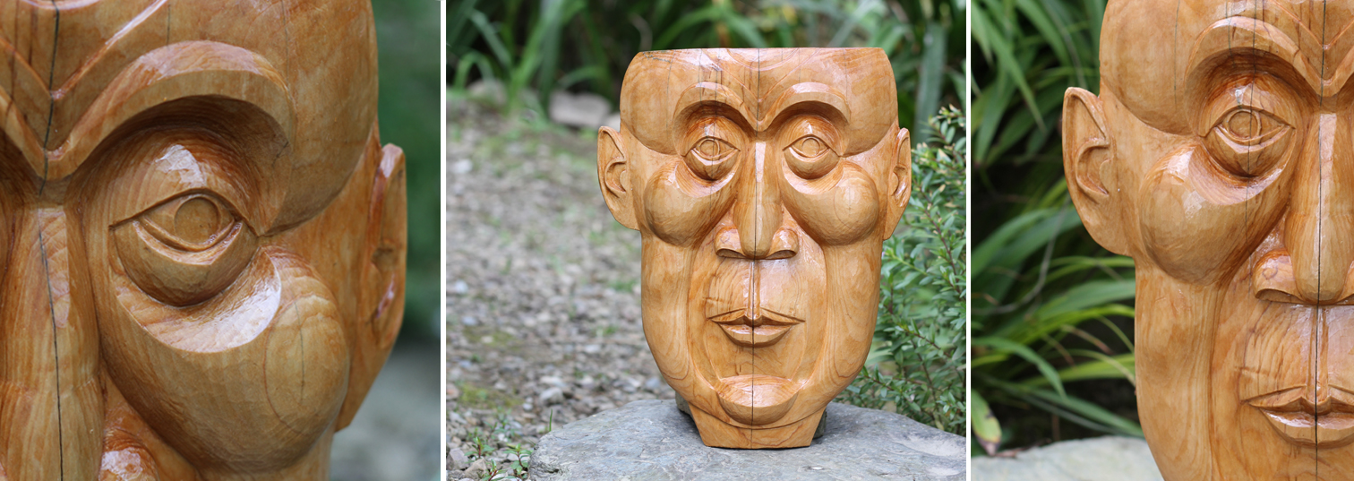 H.H. Face - A cedar wood sculpture of a contemplative face